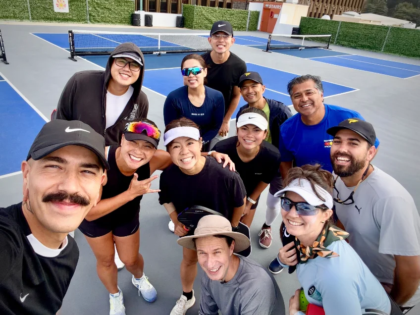 Group selfie of an offsite crew on the courts